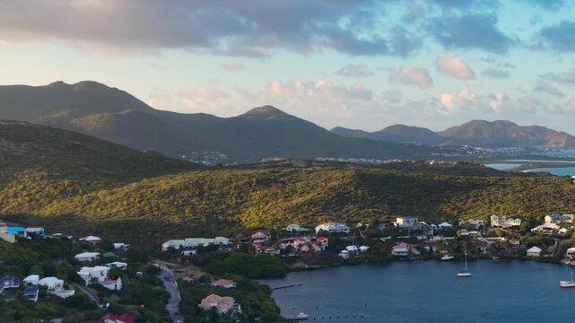 Aerial view of Oyster Pond on Saint Martin island in the Caribbean Sea. Coastal town with residential buildings and resort hotels is located on the border of French and Dutch sides.