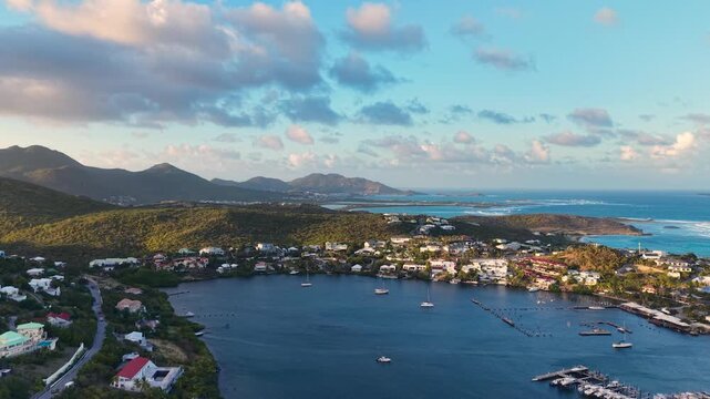 Aerial view of Oyster Pond on Saint Martin island in the Caribbean Sea. Coastal town with residential buildings and resort hotels is located on the border of French and Dutch sides.