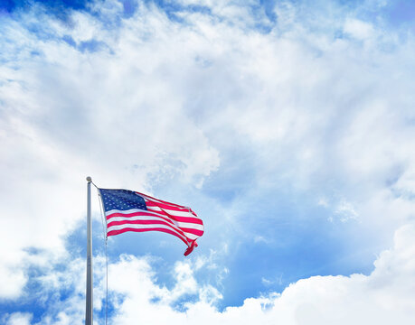American Flag at flagpole over dramatic sky