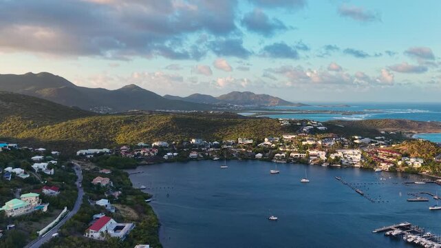 Aerial view of Oyster Pond on Saint Martin island in the Caribbean Sea. Coastal town with residential buildings and resort hotels is located on the border of French and Dutch sides.