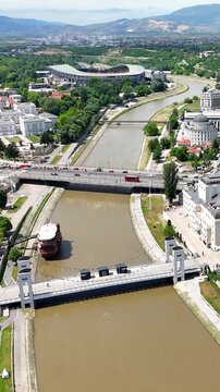 Aerial drone view of Skopje, North Macedonia. Panoramic view of the Vardar River and the architecture of the capital city.