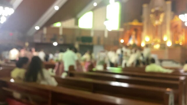 Wedding photoshoot at the altar of a chapel featuring the newlywed couple along with their entourage. Blurs