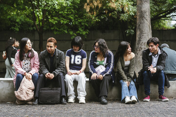 Fototapeta premium Hispanic young adults interacting and talking at outdoors