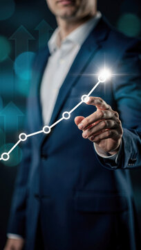 Businessman touching upward trending graph on digital interface showing business growth and success