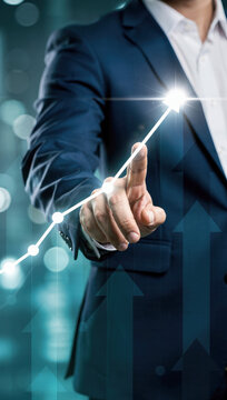 Businessman touching upward trending graph on digital interface showing business growth and success
