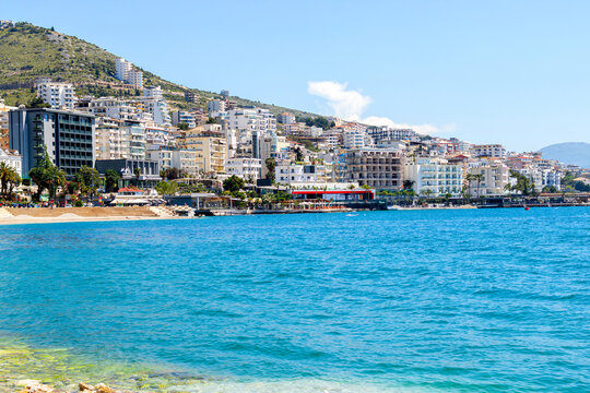 Beautiful beach with white pebbles and blue waters in european city.