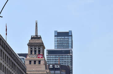 Naklejka premium Canada Life and Tata Consultancy Services signs displayed on the tops of office buildings along University Avenue in downtown Toronto, surrounded by modern high-rise commercial architecture, May 2026