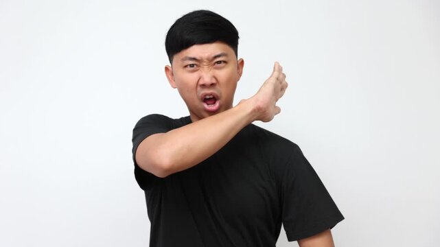 Asian man in black t-shirt showing stop, cross hands, and rejection gestures with shocked face