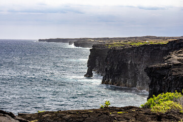 Volcanic sea cliffs and Holei Sea Arch along the Pacific Ocean coastline in Hawaii Volcanoes National Park Big Island Hawaii © Joao Vieira