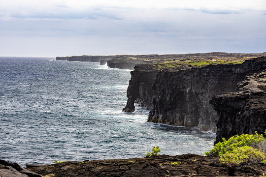 Volcanic sea cliffs and Holei Sea Arch along the Pacific Ocean coastline in Hawaii Volcanoes National Park Big Island Hawaii