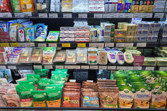 Kuala Lumpur, Malaysia - May 28, 2026: A close-up, eye-level commercial view of heavily stocked retail grocery shelves showcasing an assortment of dairy products inside Seibu supermarket.