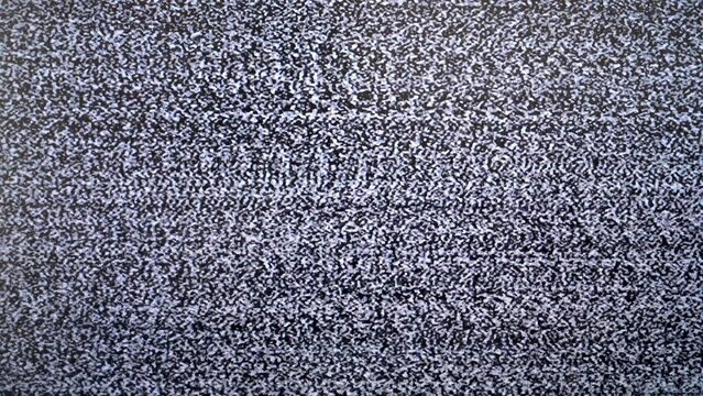 Close-up of static tv screen with black and white noise