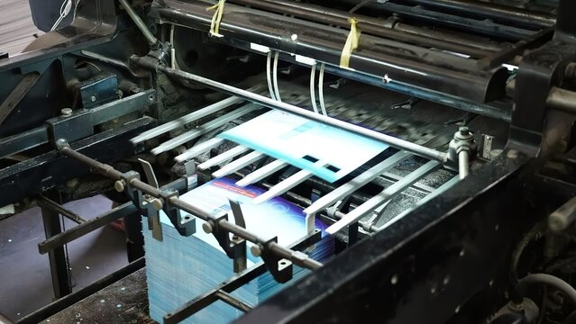 Printer with paper tray in a printing factory setting