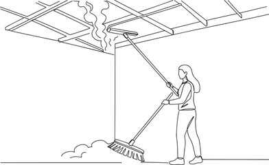 Fototapeta premium Woman cleaning ceiling with broom, focused on removing debris and dust.