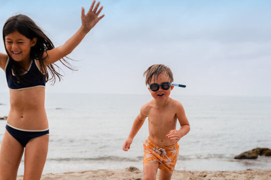 Kids Enjoy Fun Time at the Beach While Playing in the Sand