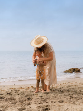 Mom helping to her son to put on goggles 