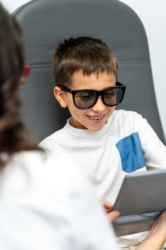 Boy Reading Vision Chart Tablet