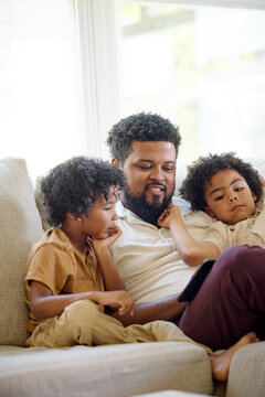 Father Enjoys Time With Children on a Cozy Sofa