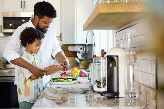 Father and Child Prepare Food in a Modern Kitchen