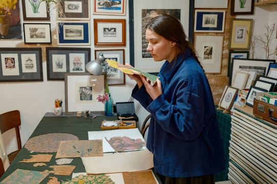 a female artist lays out her works on a table