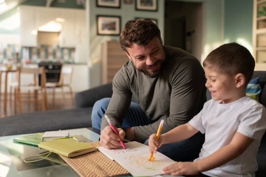 Happy father and son drawing pictures together