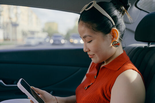 Portrait of a Woman Using Smartphone in Car
