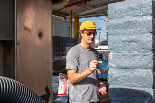 Man Inserting Coins at a Carwash