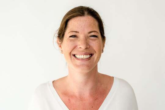 Smiling woman against white background.