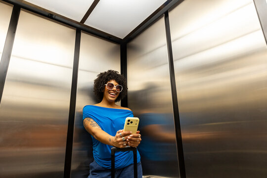 Black Girl on cell phone travel elevator fashion