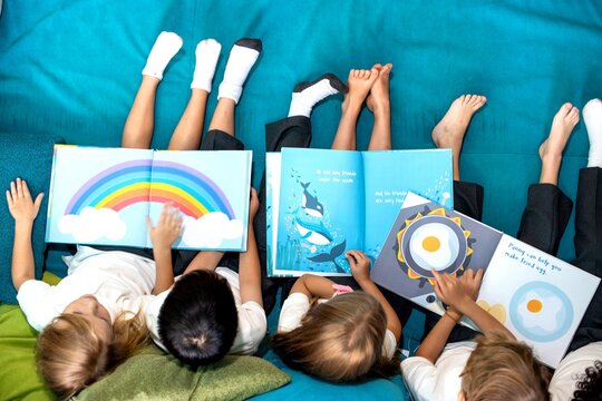 Children reading colorful picture books.