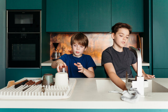 Creative Kids Exploring Culinary Fun in a Modern Kitchen