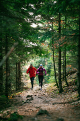 Fototapeta premium Happy Couple Running on a Forest Trail
