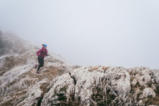Trail Runner in Misty Mountain Landscape