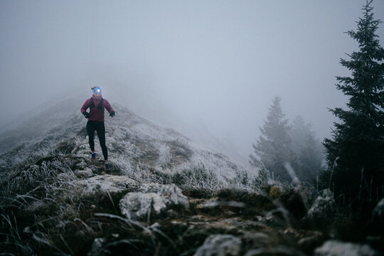 Trail Runner in Misty Mountain Landscape