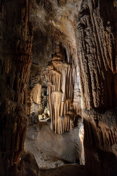 Brown cave interior with stalactites and stalagmites natural rock formations