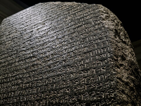 Imposing Ancient Rosetta Stone Unveiling Egyptian Hieroglyphs and Rich History in Dramatic Lighting
