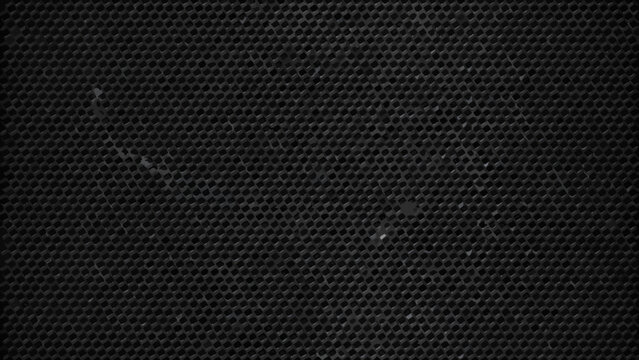 Dark gray perforated metal sheet with a repeating diamond grid pattern industrial texture
