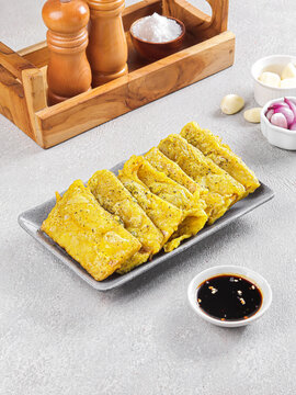 Traditional Indonesian Tempe Mendoan with Sweet Soy Dipping Sauce on White Plate