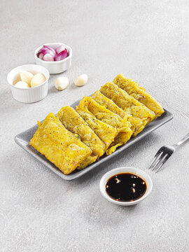 Traditional Indonesian Tempe Mendoan with Sweet Soy Dipping Sauce on White Plate