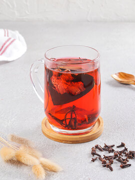 Traditional Indonesian Wedang Uwuh Herbal Drink in Glass Mug on Light Background. Wedang Uwuh Traditional hot drink Javanese Herbal Tea with Natural Spices