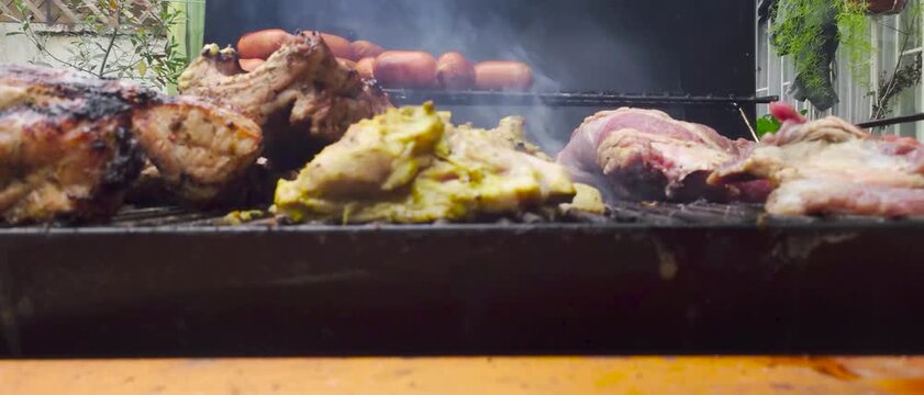 Hands Grilling Beef on a Barbecue &ndash; Close-Up of Meat Cooking on the Grill (asado)