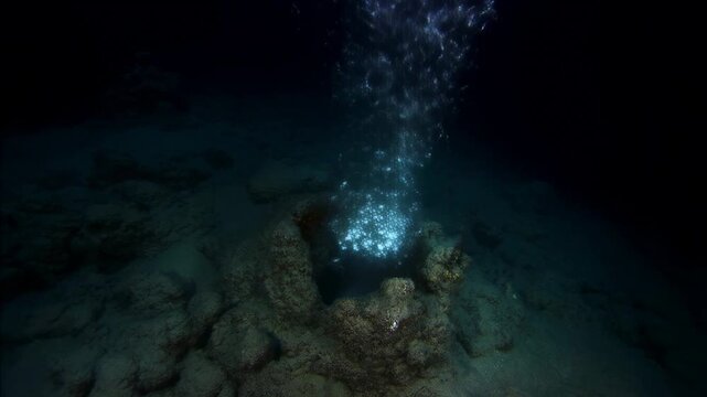 Bubbles erupt from ocean floor vent in deep sea exploration sequence