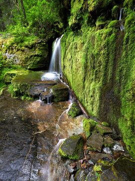 Waterfall cascades downrock shelf.