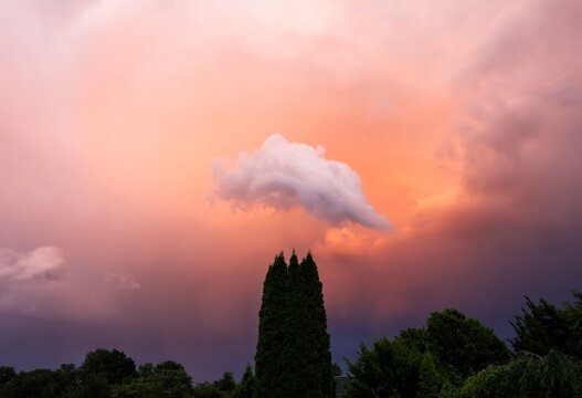 Dramatic storm clouds painting a colorful sunset sky