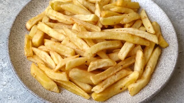 Golden French fries fried with salt and spices, unhealthy takeaway food. French fries as a food background for your design