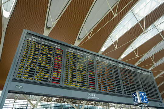 Shanghai, China - Aug 20, 2023: Domestic and international departure boards in Shanghai Pudong International Airport's Terminal 2 Building.