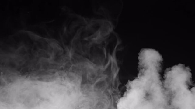 Abstract white smoke plumes rising against a dark black background.