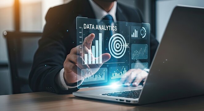 Businessman analyzing data on a laptop with virtual analytics interface