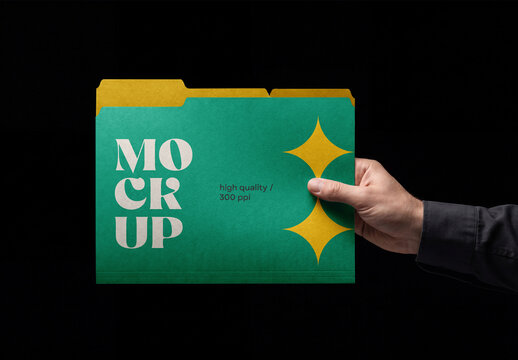 Front view of a male hand holding a paper file folder mockup isolated on a solid black background