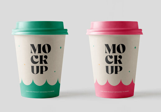 Front view of two disposable paper coffee cups mockup side by side with green and pink plastic lids isolated on a solid light grey background